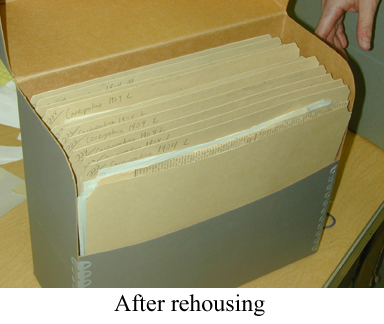 Folders neatly arranged in archival box with caption "After rehousing"